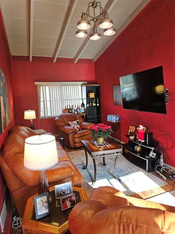 a bedroom with furniture and a flat screen tv