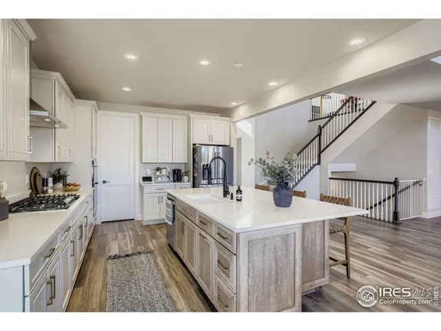 a kitchen with a stove a sink a refrigerator and a cabinets