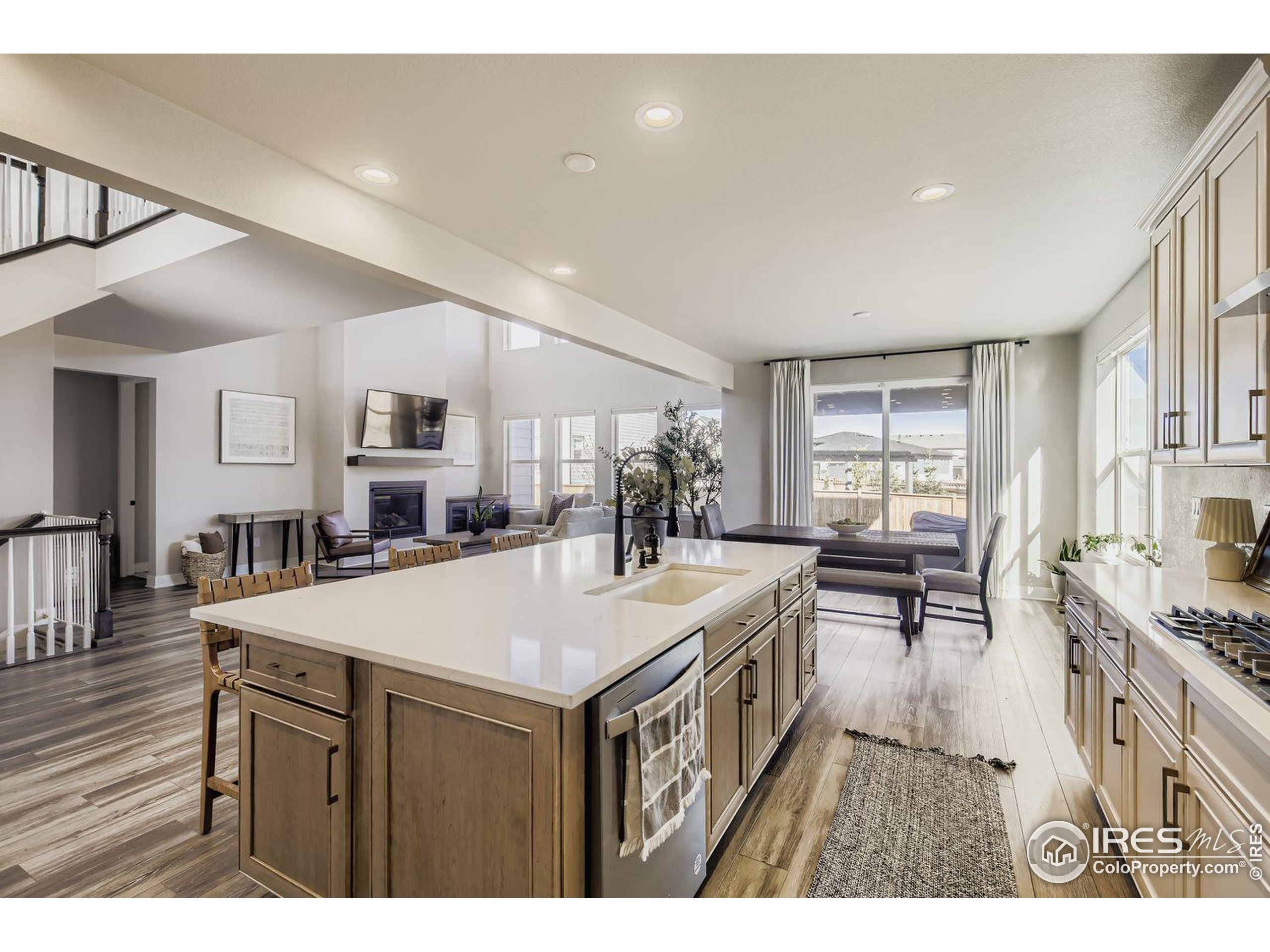 4359 Shivaree Street Timnath, CO 80547 - Photo 12 of 29 a view of a dining room kitchen with a table chairs and a large window