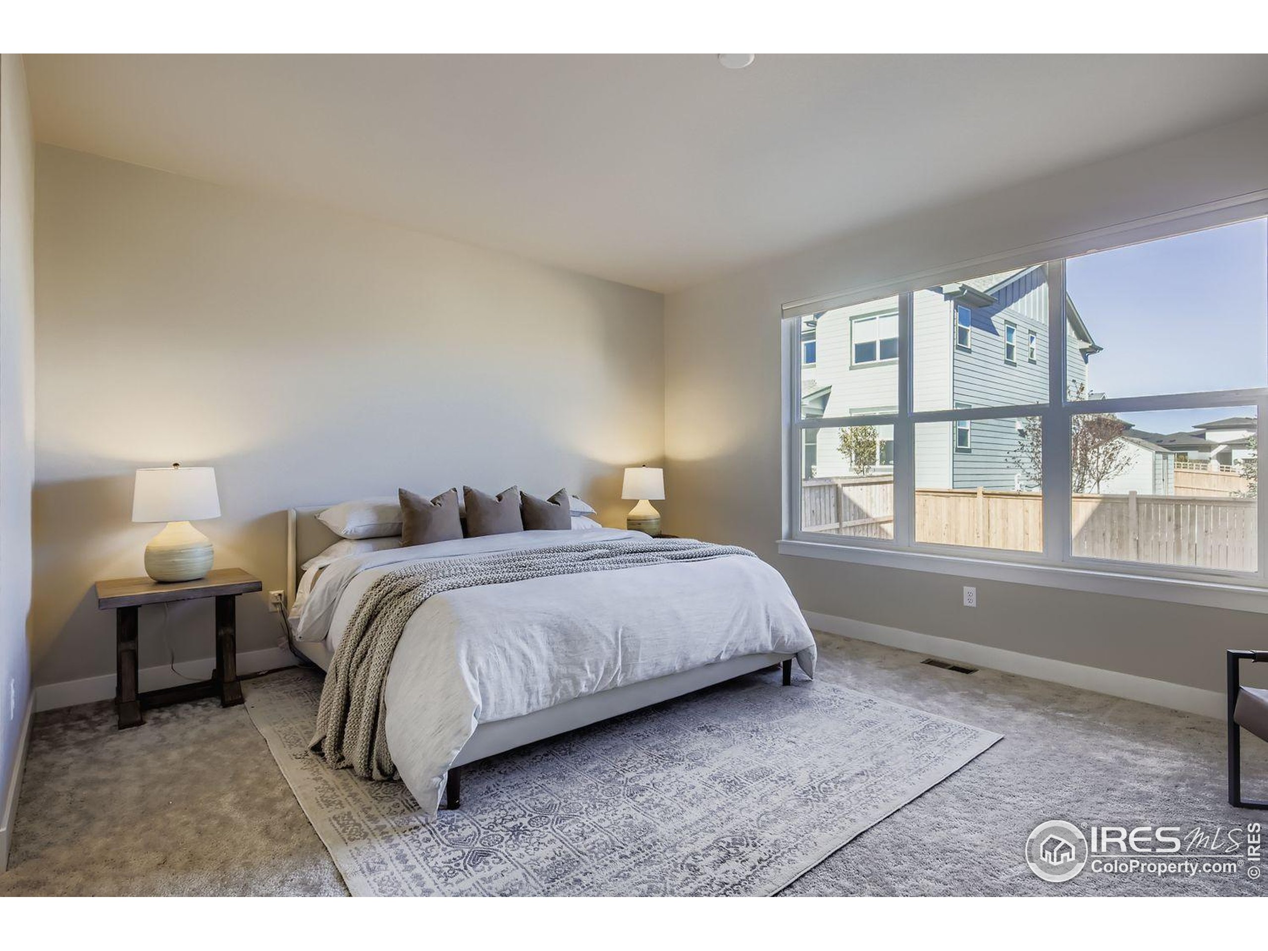4359 Shivaree Street Timnath, CO 80547 - Photo 14 of 29 a spacious bedroom with a bed and a large window