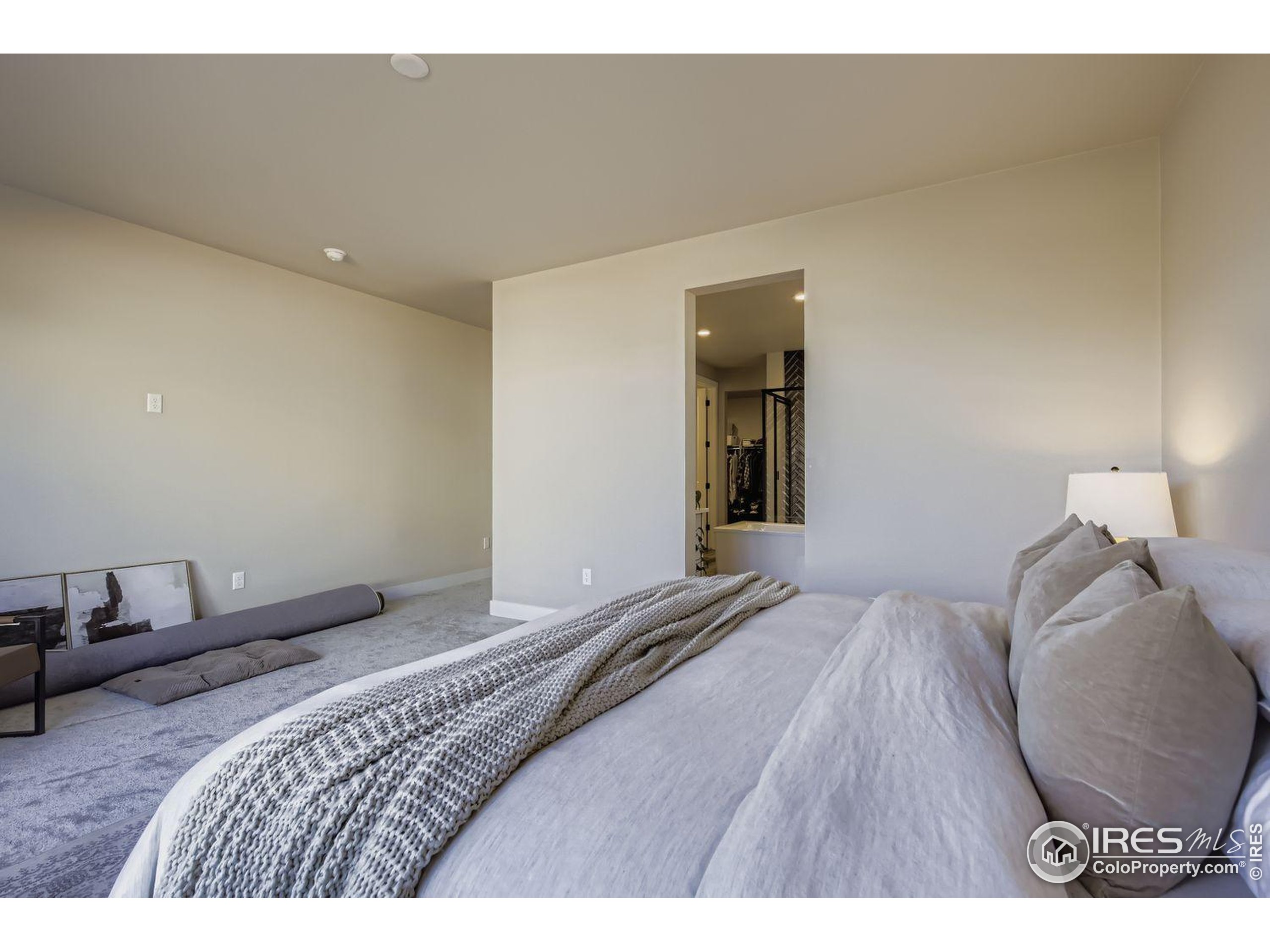 4359 Shivaree Street Timnath, CO 80547 - Photo 18 of 29 a bedroom with a bed and a wooden floor