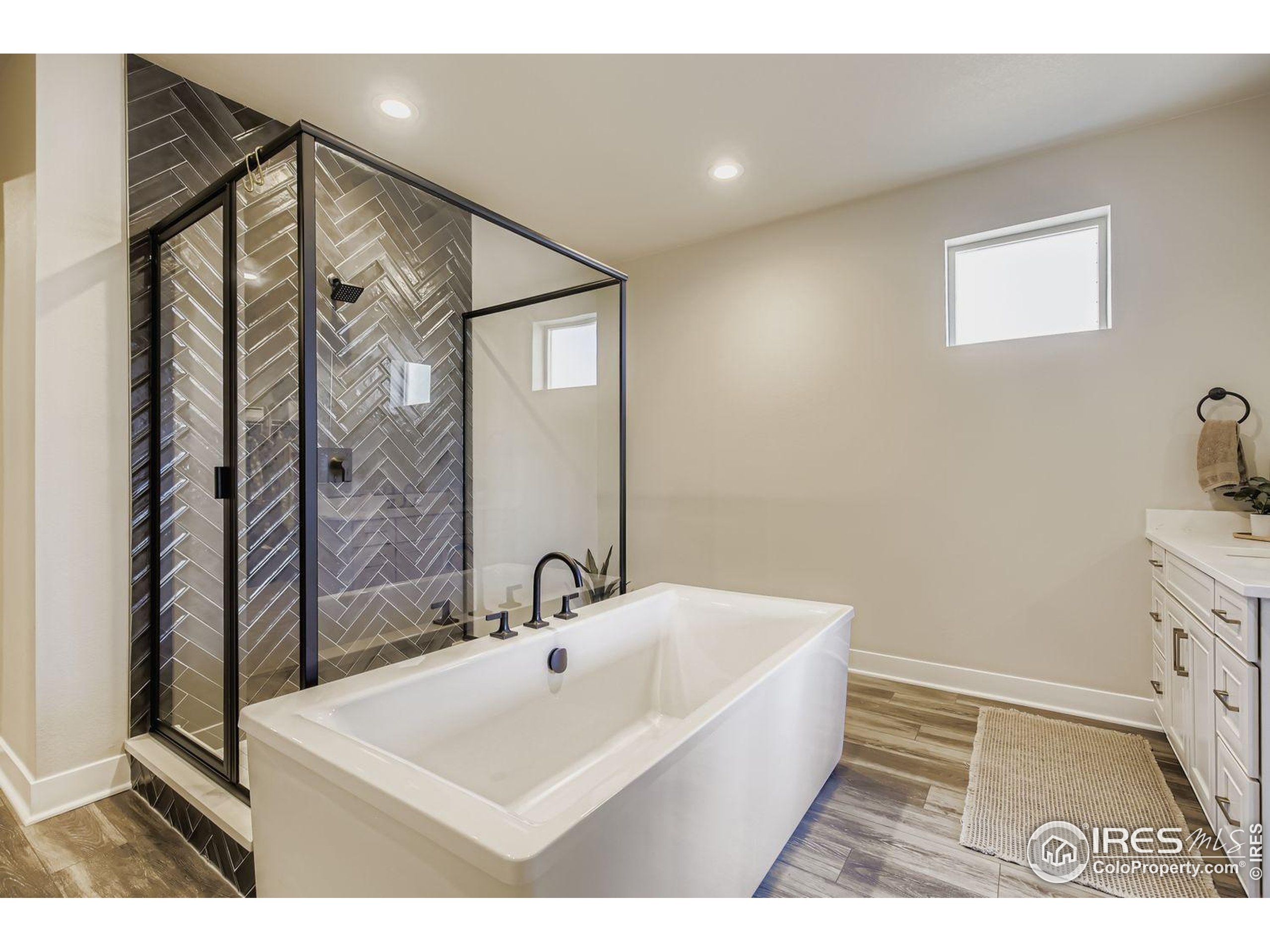 4359 Shivaree Street Timnath, CO 80547 - Photo 20 of 29 a bathroom with a sink a mirror and a shower