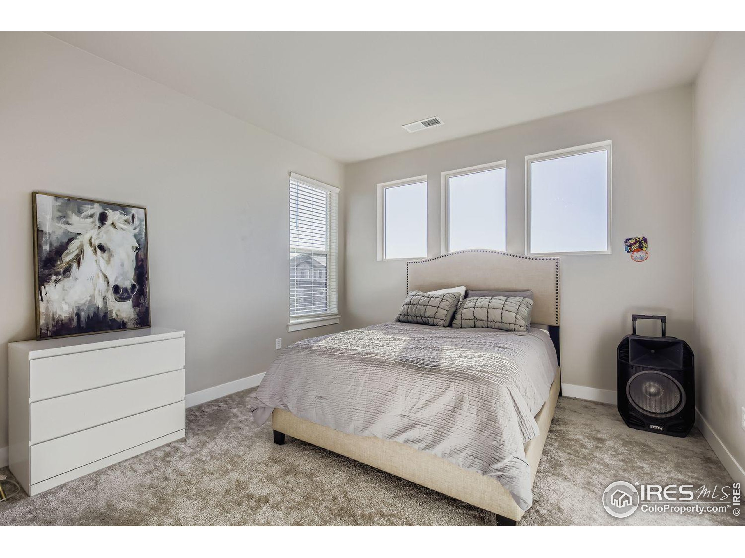 4359 Shivaree Street Timnath, CO 80547 - Photo 22 of 29 a bedroom with a bed and a painting on the wall