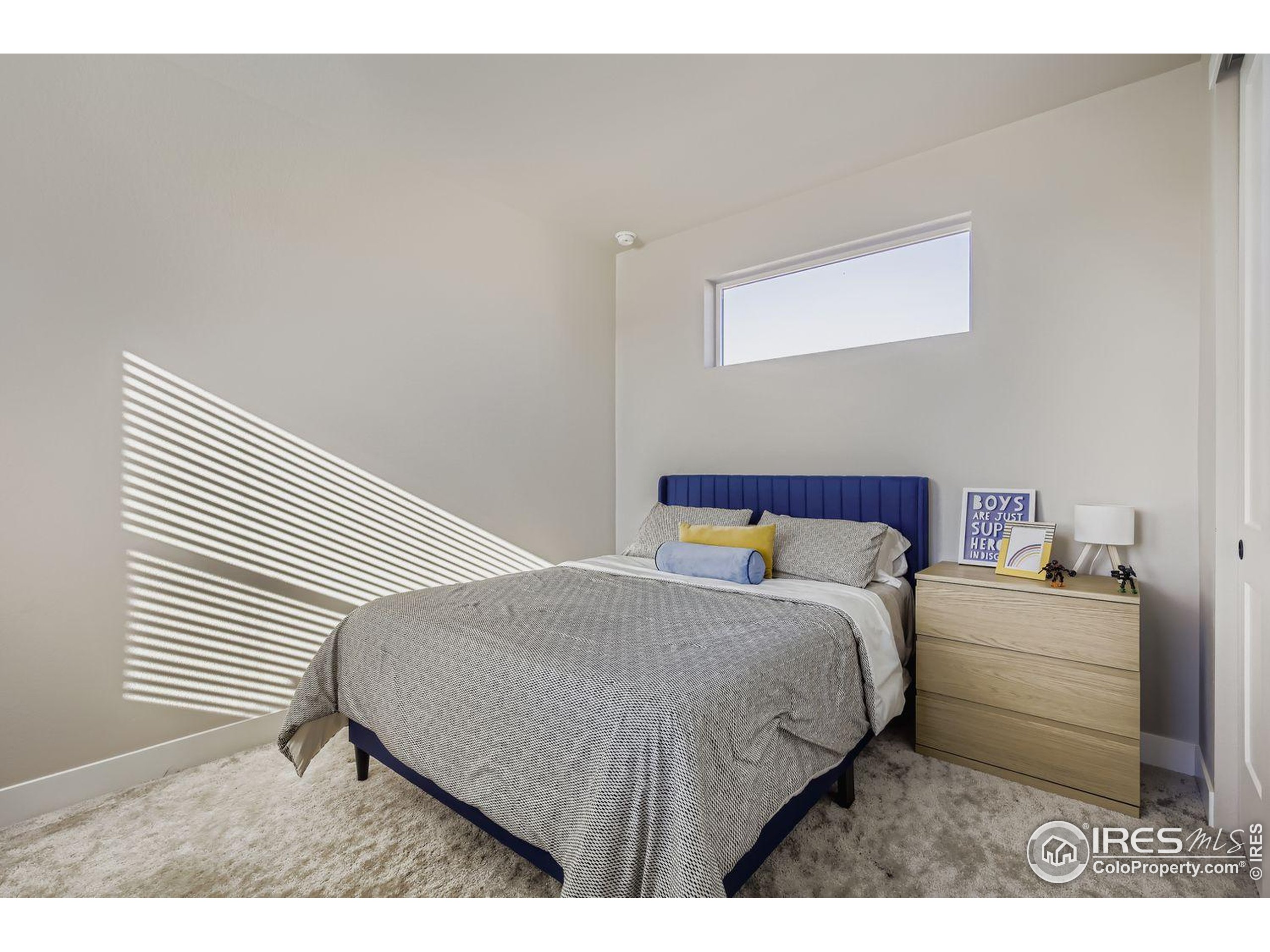 4359 Shivaree Street Timnath, CO 80547 - Photo 23 of 29 a bedroom with a bed and a cabinets