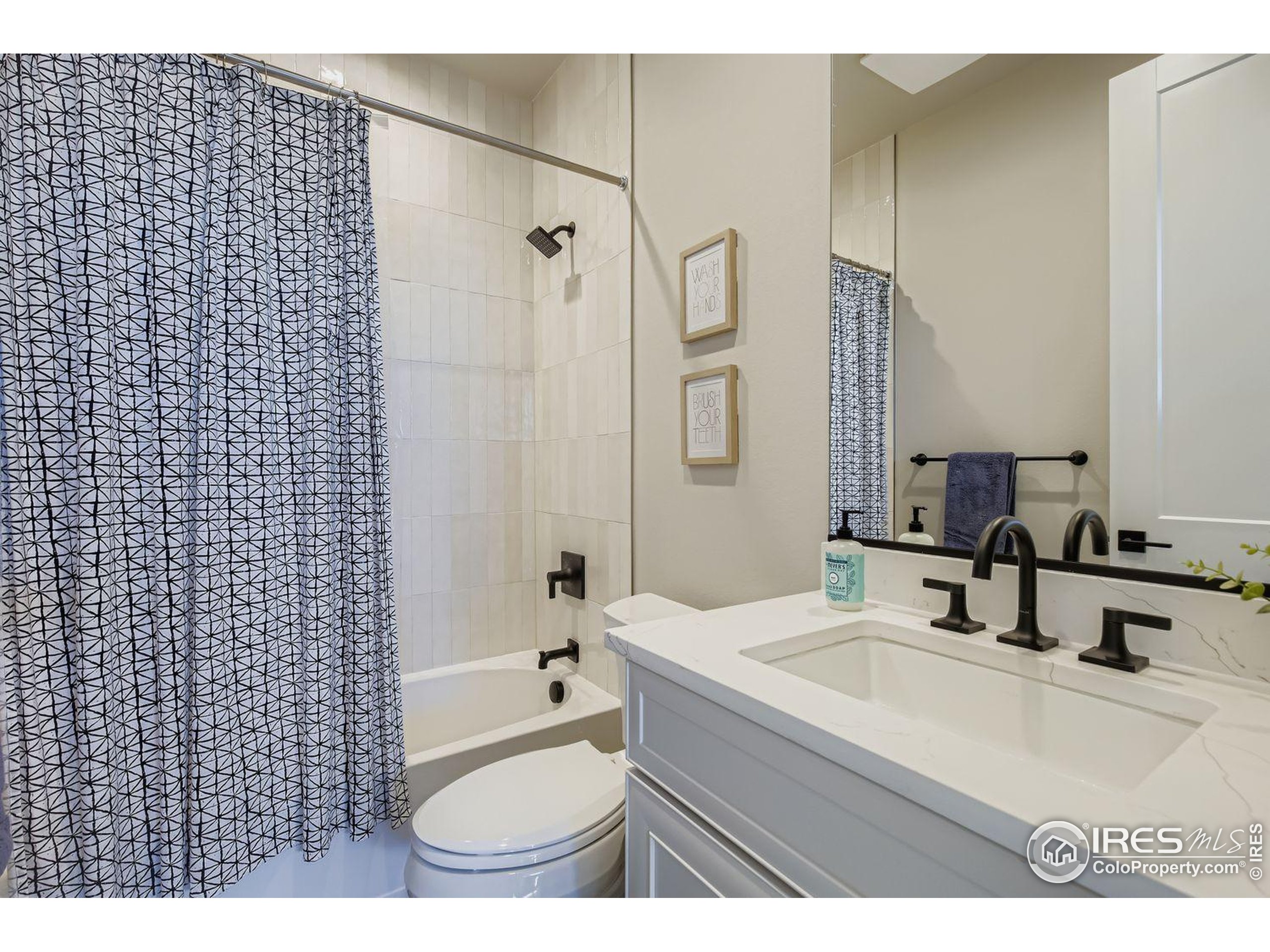 4359 Shivaree Street Timnath, CO 80547 - Photo 24 of 29 a bathroom with a sink a toilet and shower