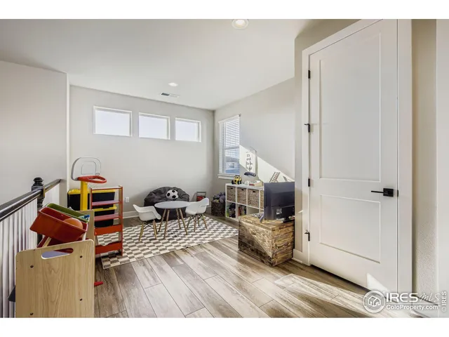 a bedroom with furniture and a wooden floor