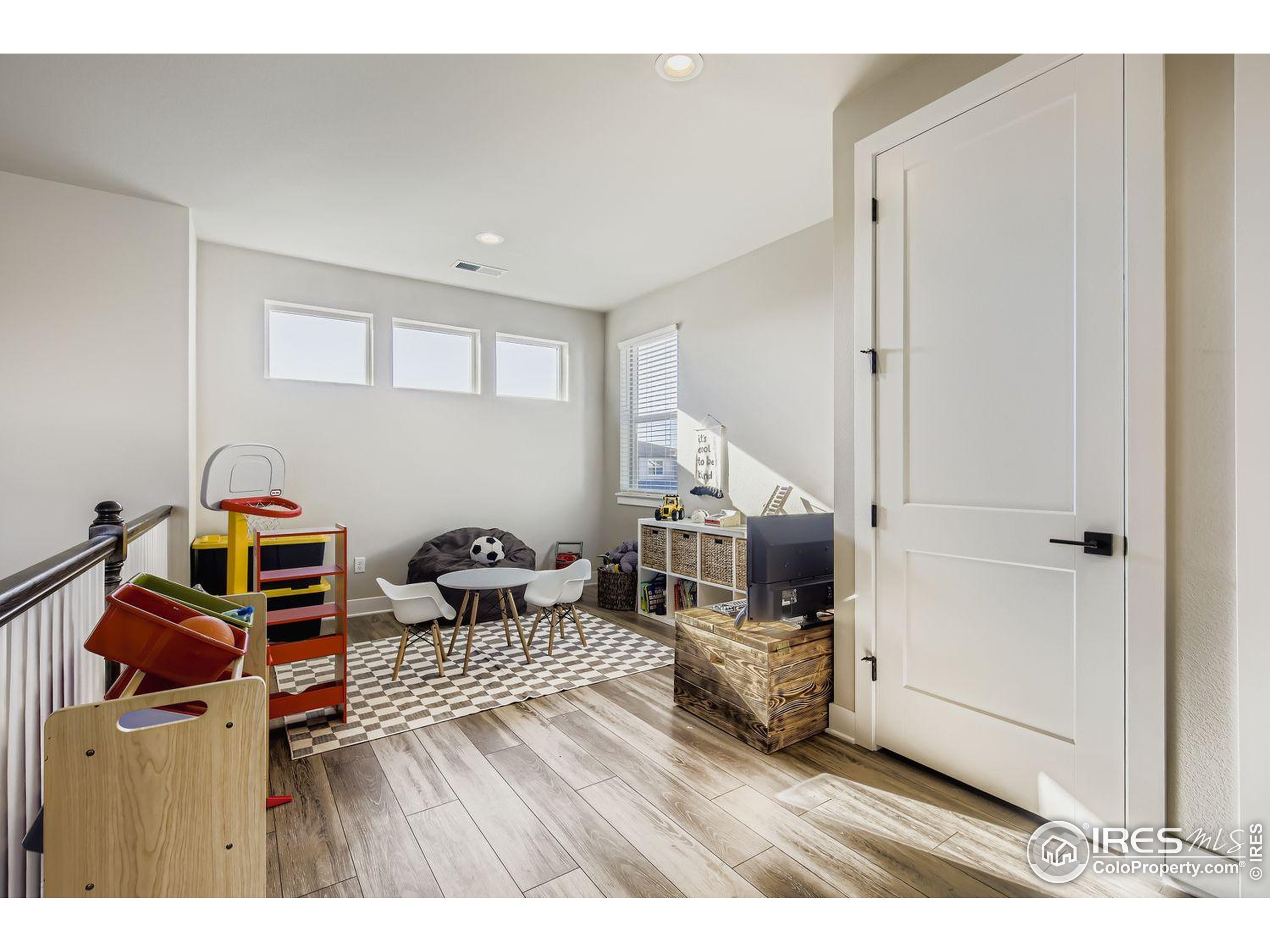 4359 Shivaree Street Timnath, CO 80547 - Photo 26 of 29 a bedroom with furniture and a wooden floor