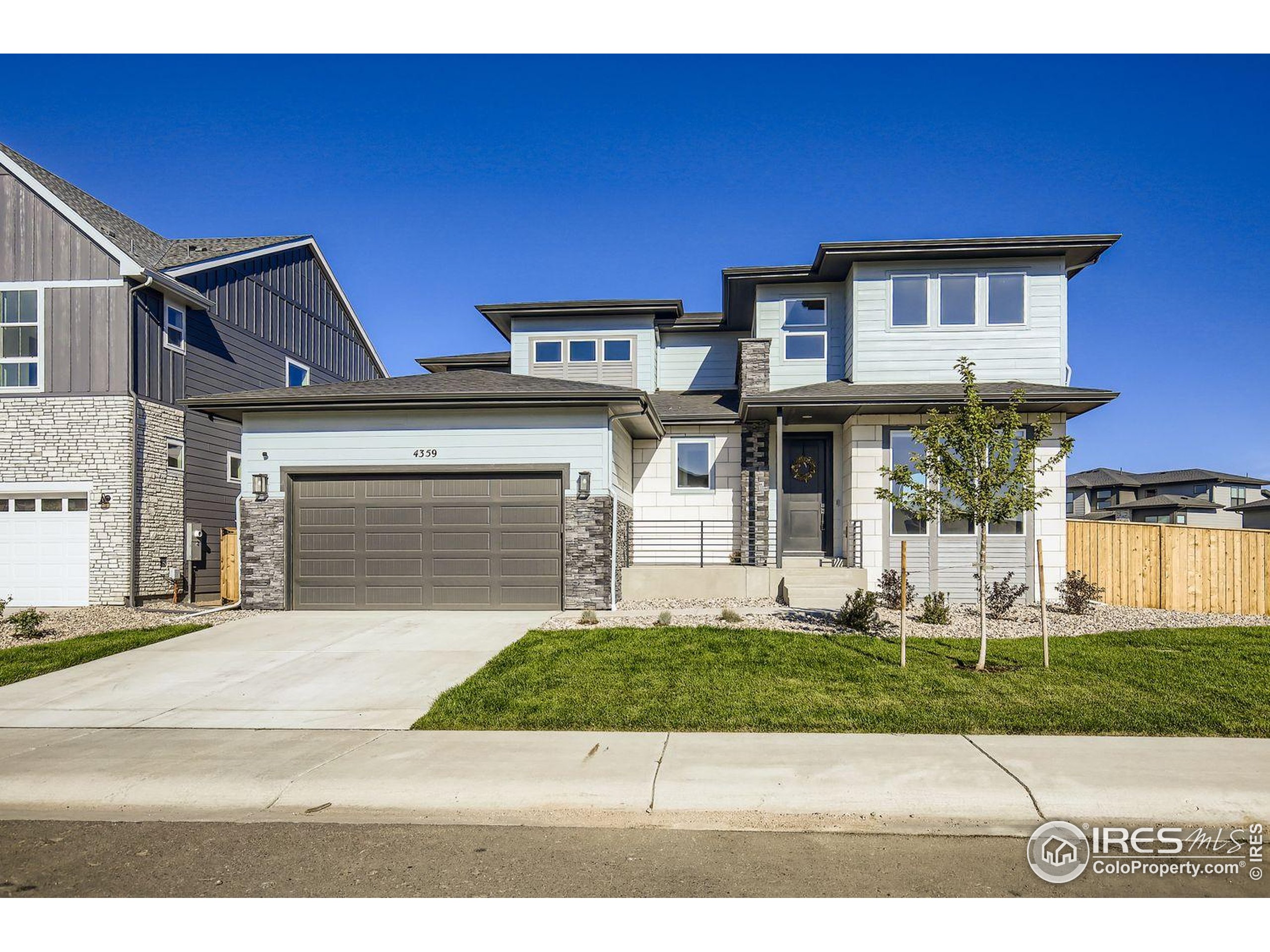 4359 Shivaree Street Timnath, CO 80547 - Photo 3 of 29 a front view of a house with garden