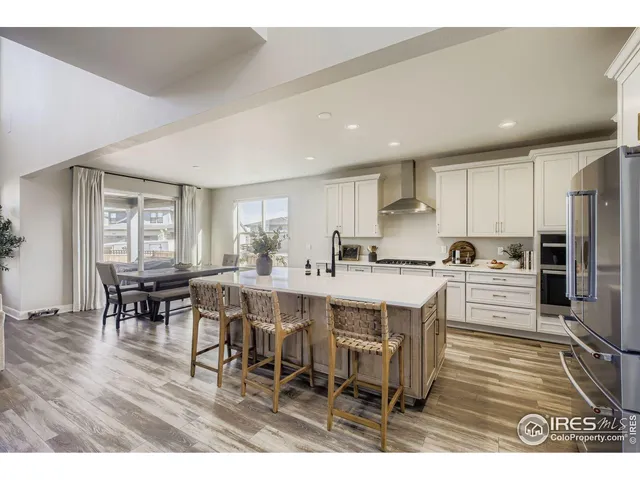 a large kitchen with a table and chairs