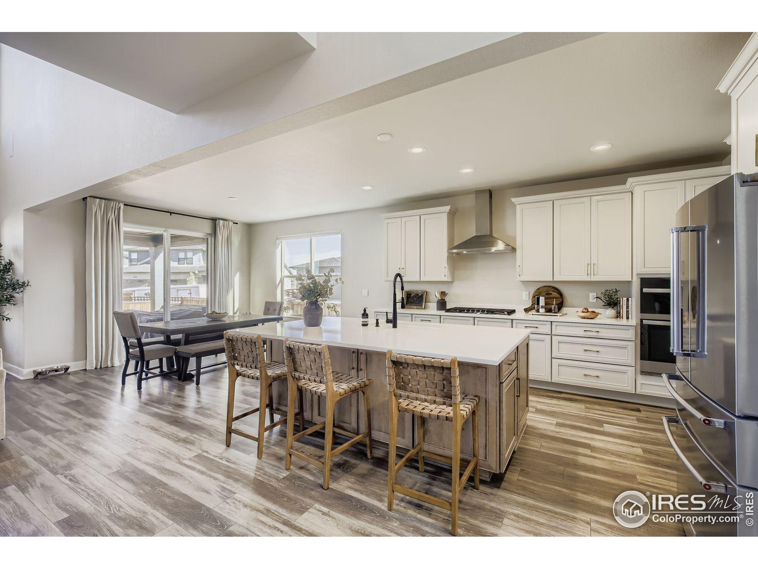 4359 Shivaree Street Timnath, CO 80547 - Photo 6 of 29 a large kitchen with a table and chairs