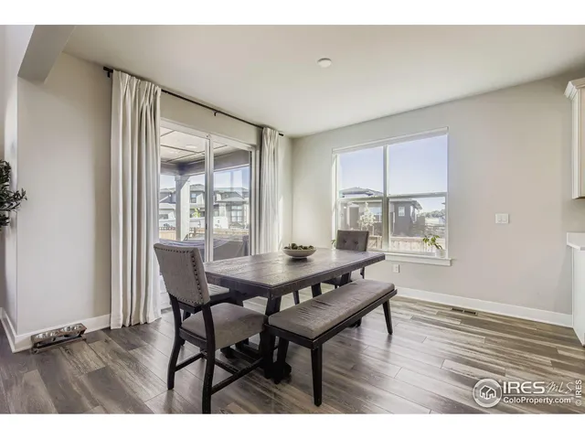 a dining room with furniture and wooden floor