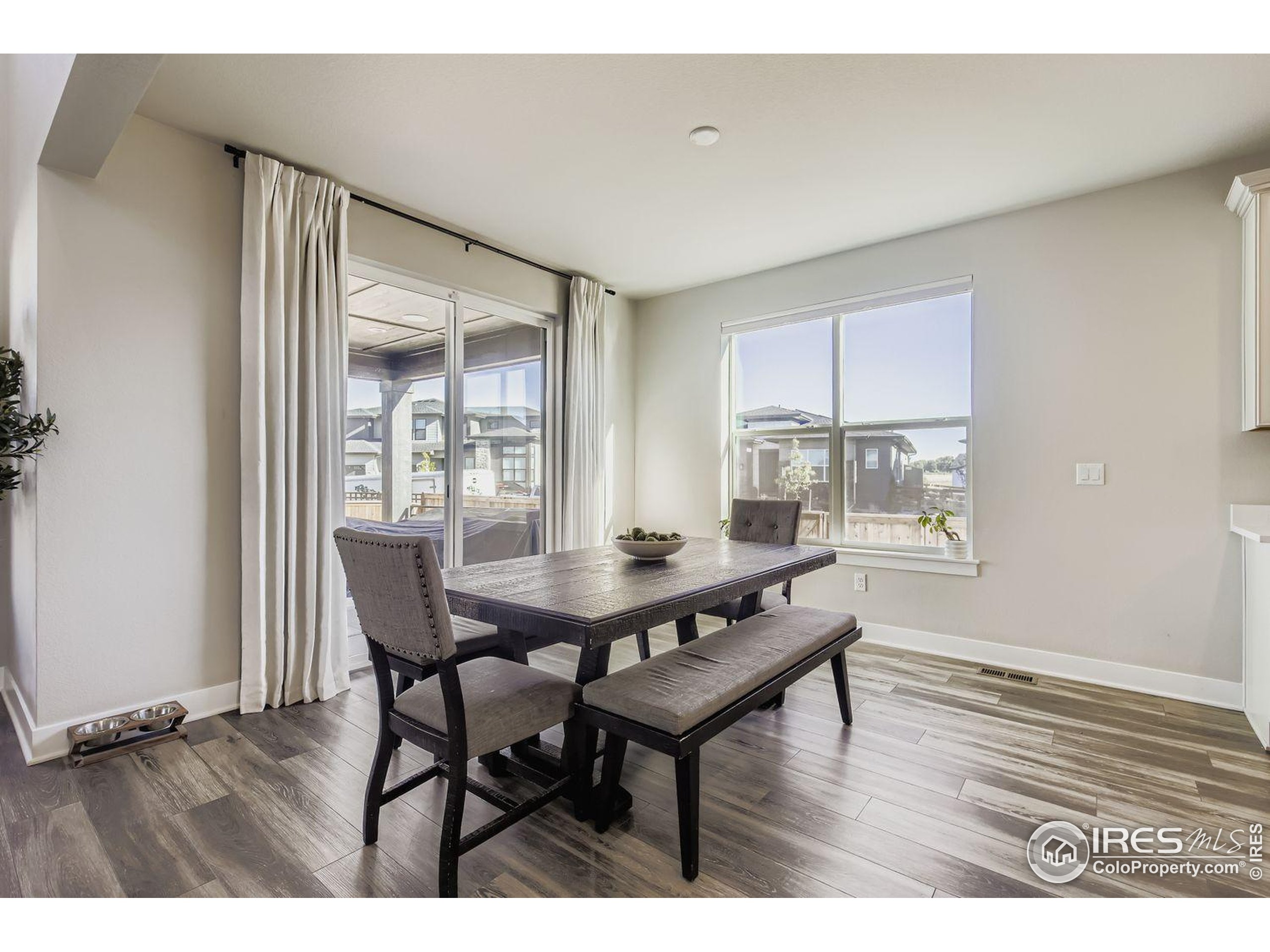 4359 Shivaree Street Timnath, CO 80547 - Photo 7 of 29 a dining room with furniture and wooden floor