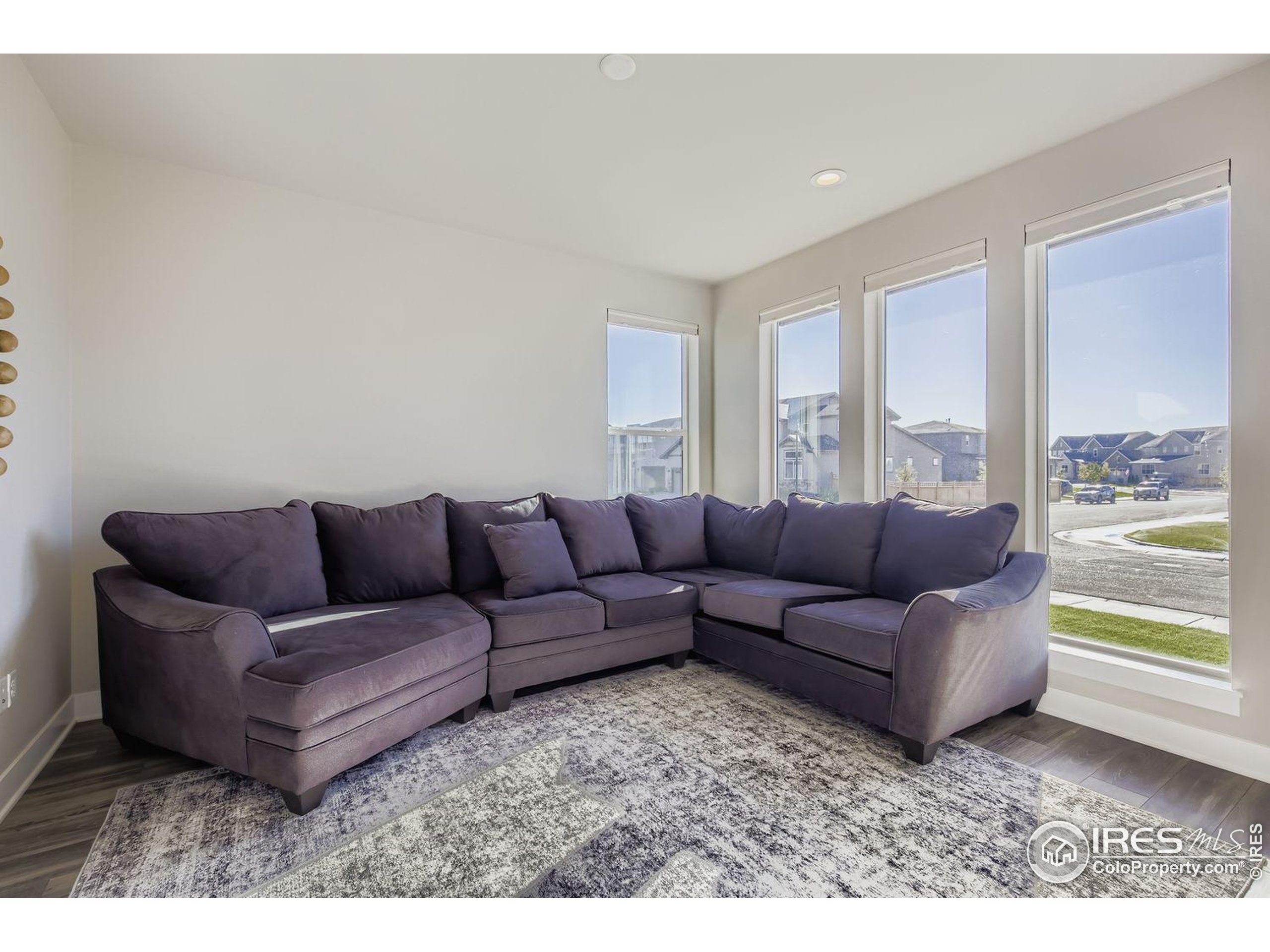 4359 Shivaree Street Timnath, CO 80547 - Photo 8 of 29 a living room with a couch and a large window