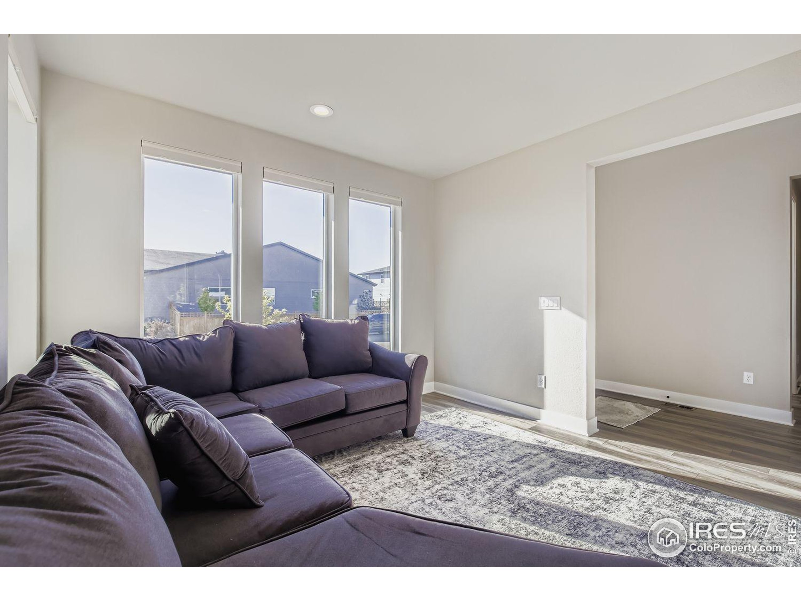 4359 Shivaree Street Timnath, CO 80547 - Photo 9 of 29 a living room with furniture and a large window