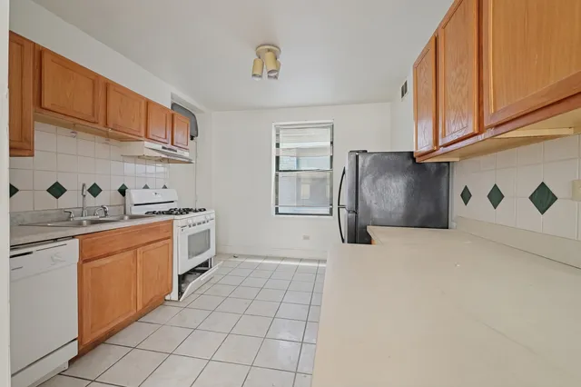 a kitchen with stainless steel appliances granite countertop a sink and cabinets