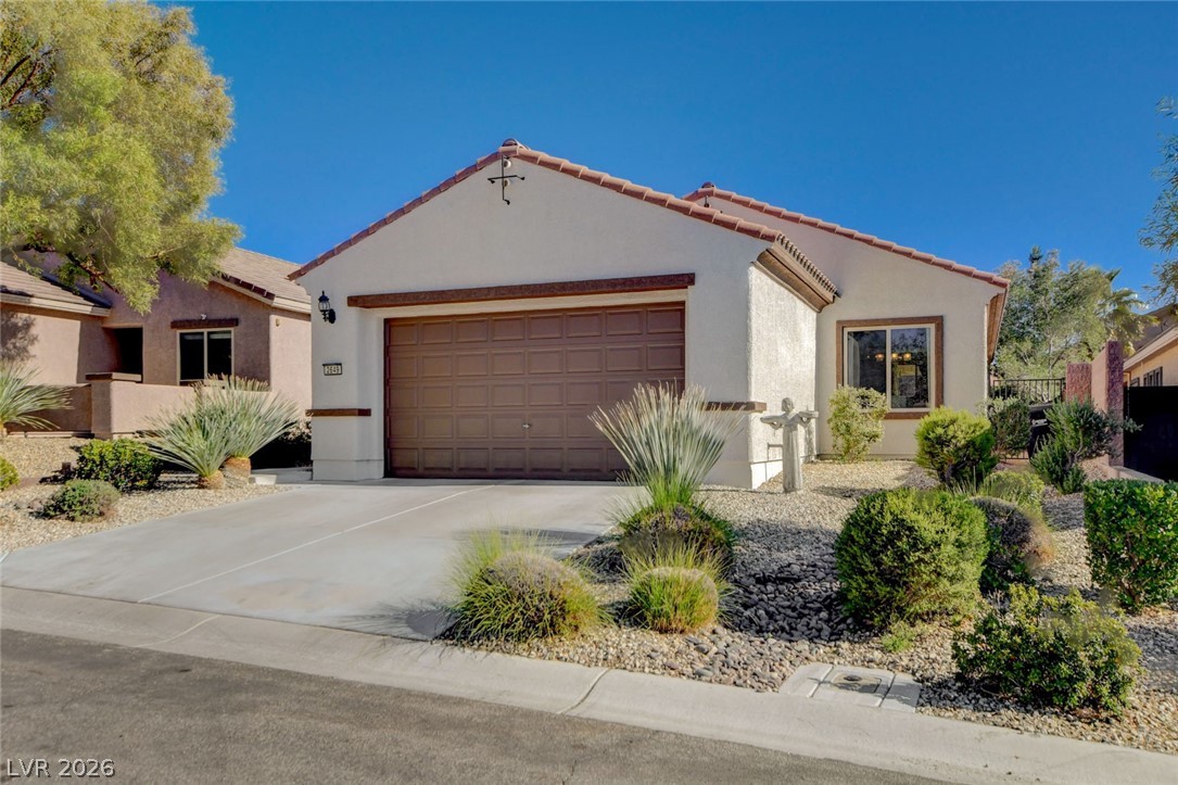 2649 Rue Marquette Avenue Henderson, NV 89044 - Photo 4 of 55 This desert dwelling showcases a single-car garage, attractive xeriscaping, and a charming front window.