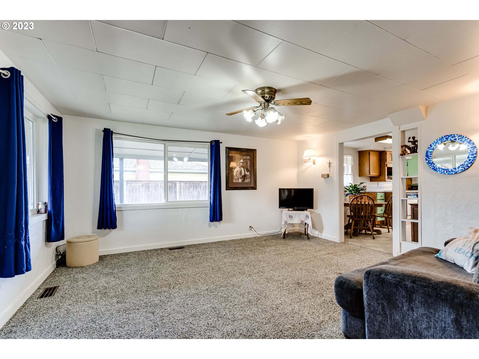 1858 I Street Springfield, OR 97477 - Photo 8 of 23 a living room with furniture a flat screen tv and a fireplace