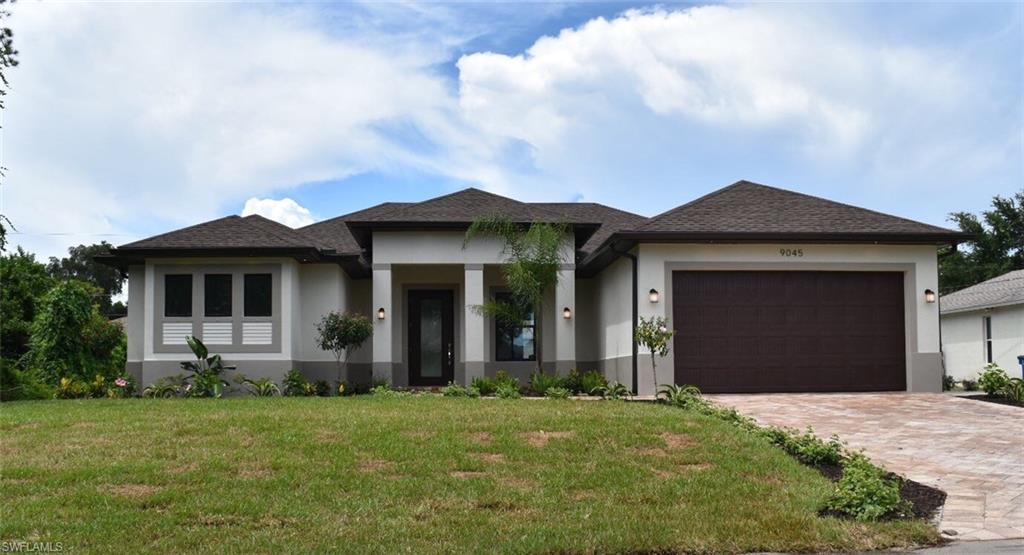 9045 Aster Road Fort Myers, FL 33967 - Photo 1 of 23 a front view of a house with a yard
