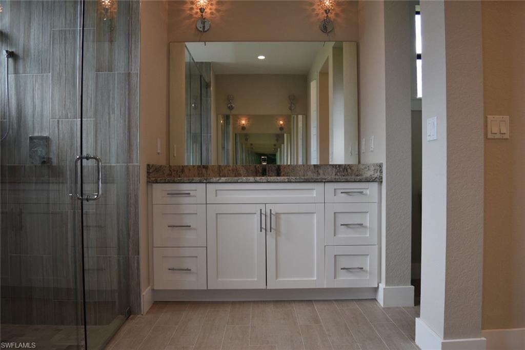 9045 Aster Road Fort Myers, FL 33967 - Photo 12 of 23 a bathroom with a granite countertop sink and a mirror