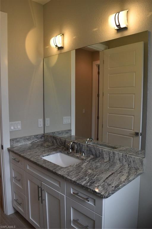 9045 Aster Road Fort Myers, FL 33967 - Photo 17 of 23 a bathroom with a granite countertop sink and a mirror