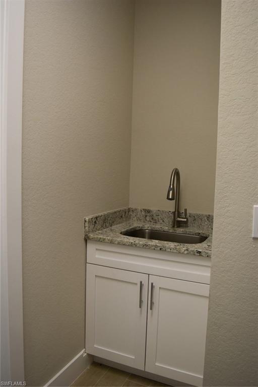 9045 Aster Road Fort Myers, FL 33967 - Photo 20 of 23 a bathroom with a granite countertop sink and vanity