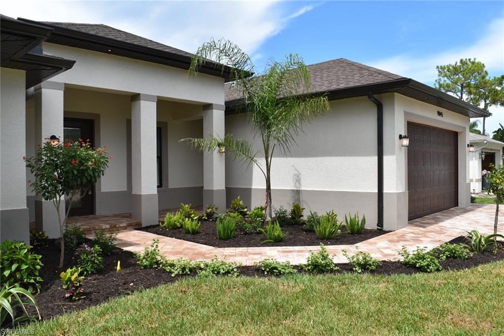 9045 Aster Road Fort Myers, FL 33967 - Photo 3 of 23 a front view of a house with a yard