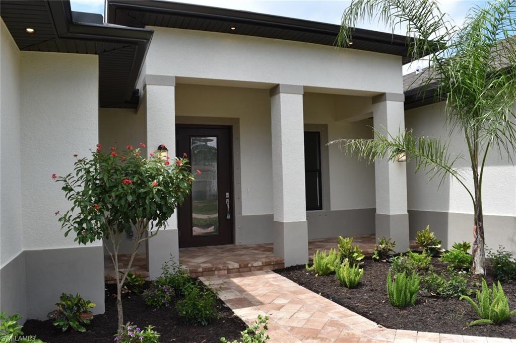 9045 Aster Road Fort Myers, FL 33967 - Photo 4 of 23 a front view of a house with a yard