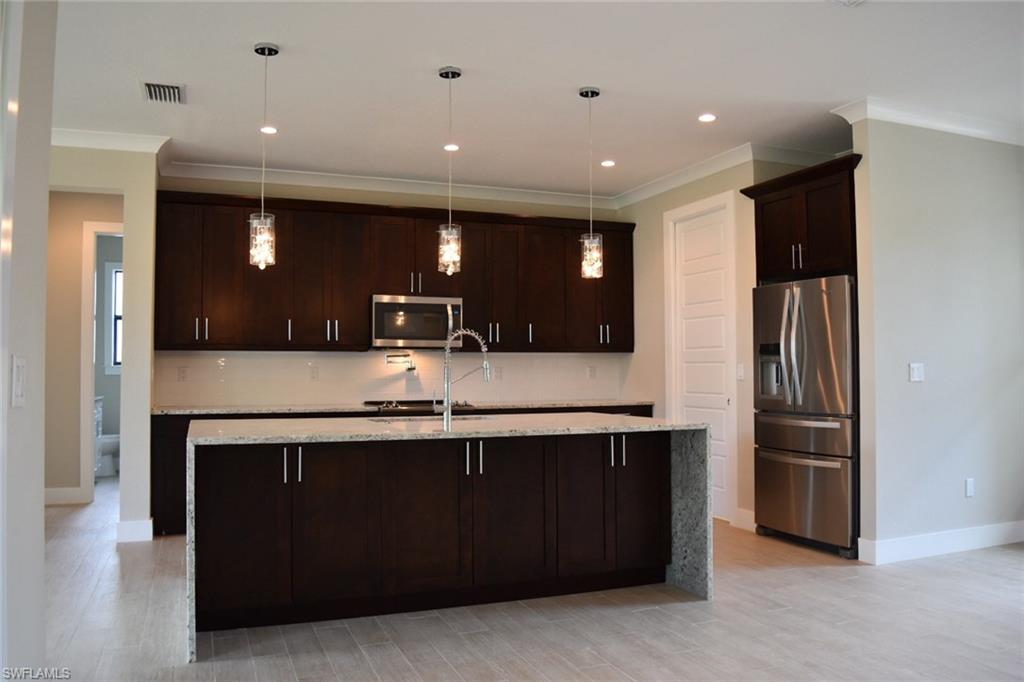 9045 Aster Road Fort Myers, FL 33967 - Photo 5 of 23 a view of a kitchen with a sink and refrigerator