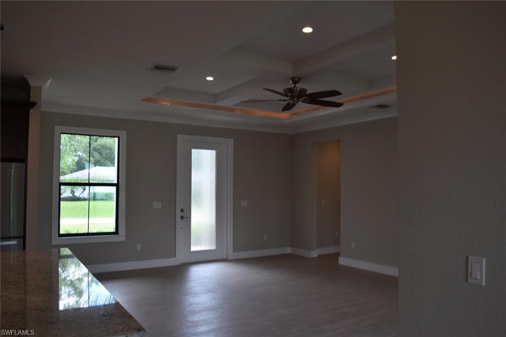 9045 Aster Road Fort Myers, FL 33967 - Photo 9 of 23 an empty room with wooden floor and windows