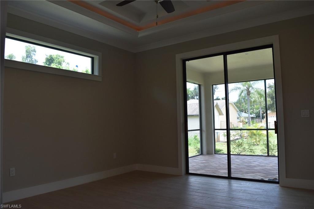 9045 Aster Road Fort Myers, FL 33967 - Photo 10 of 23 a view of empty room with wooden floor and fan
