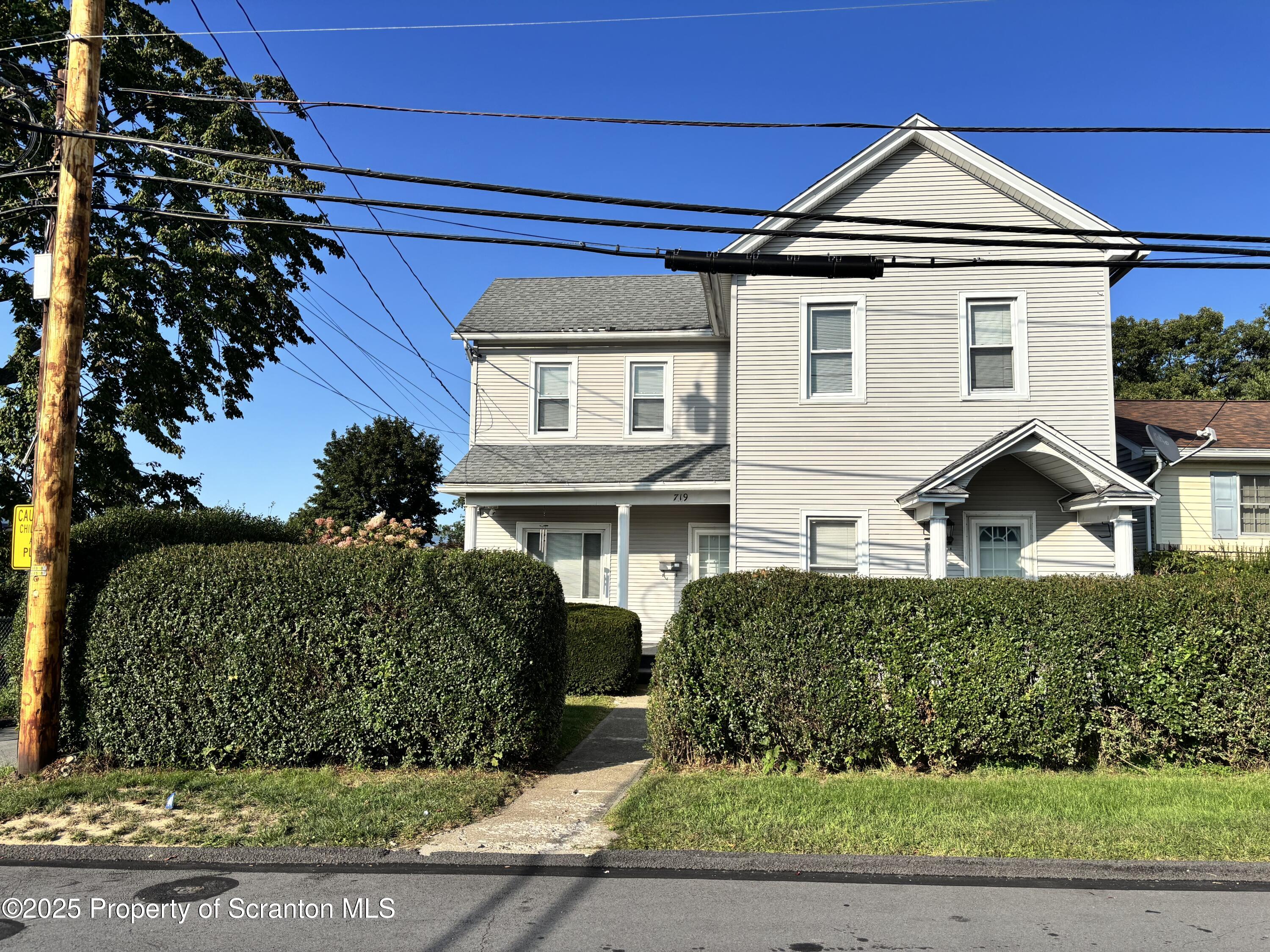 front view of a house with a yard