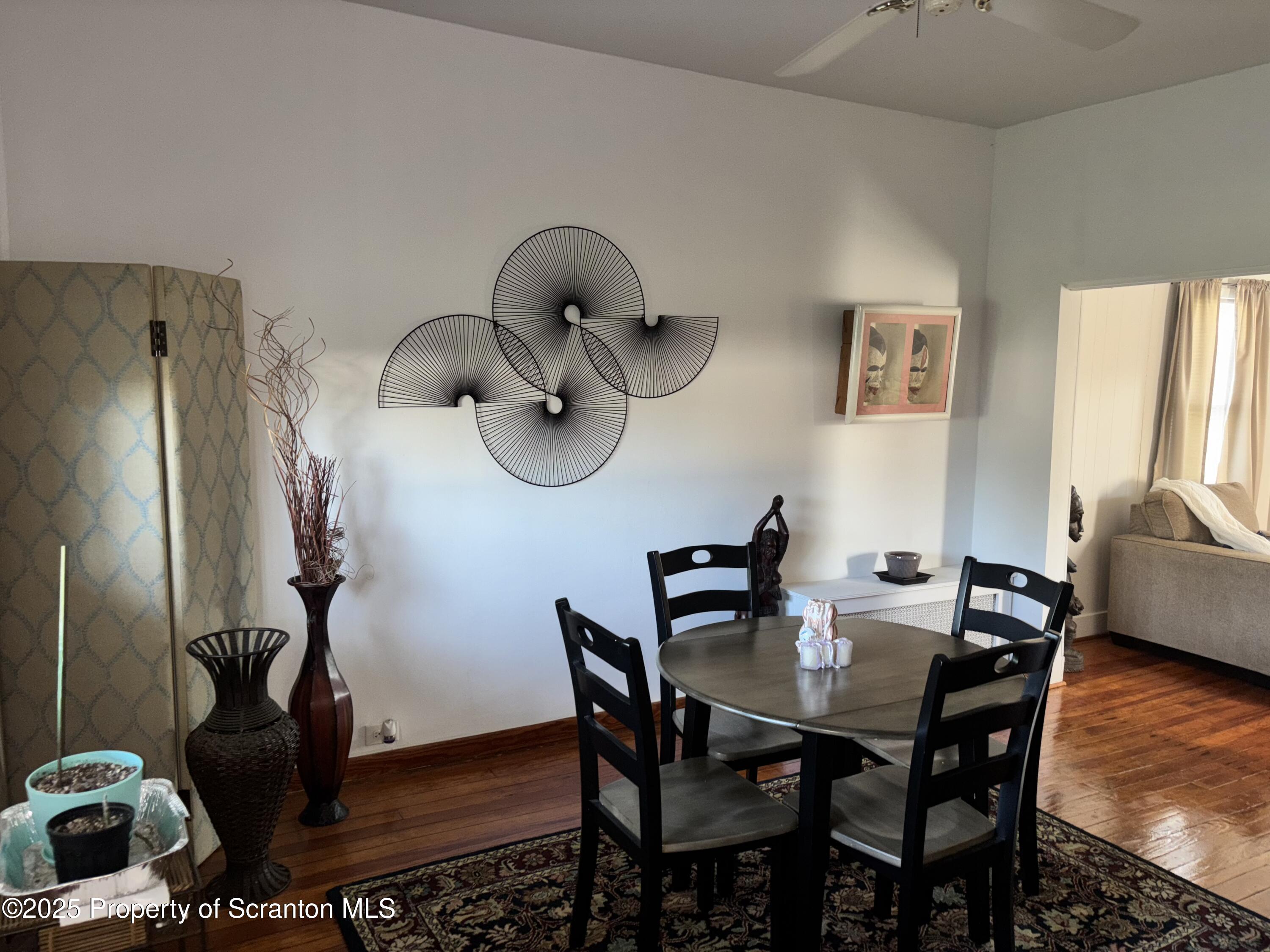 719 Saginaw Street Scranton, PA 18505 - Photo 11 of 23 a view of a dining room with furniture and wooden floor