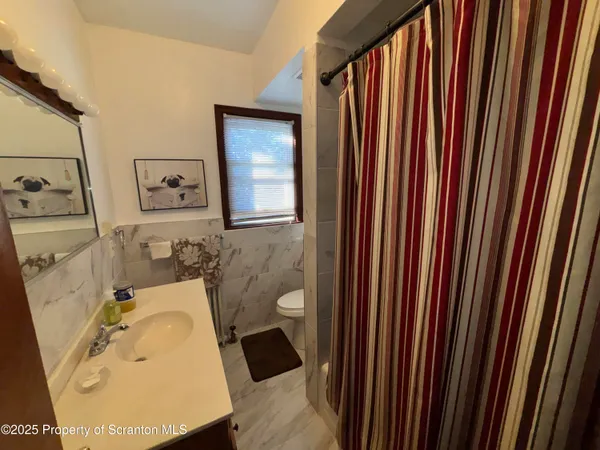 a bathroom with a sink toilet and mirror
