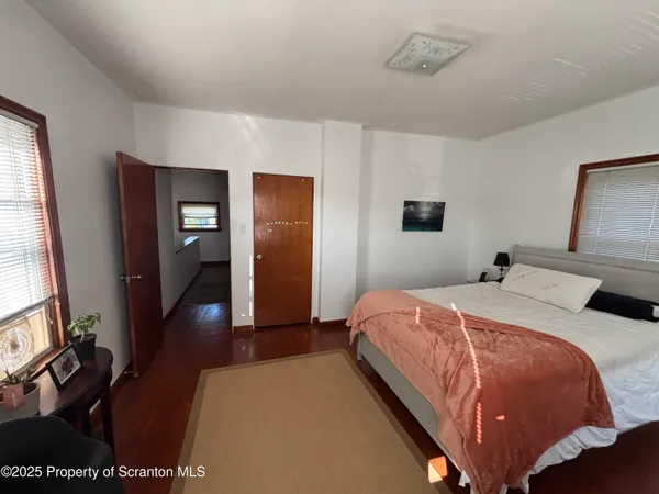 a bedroom with bed and window