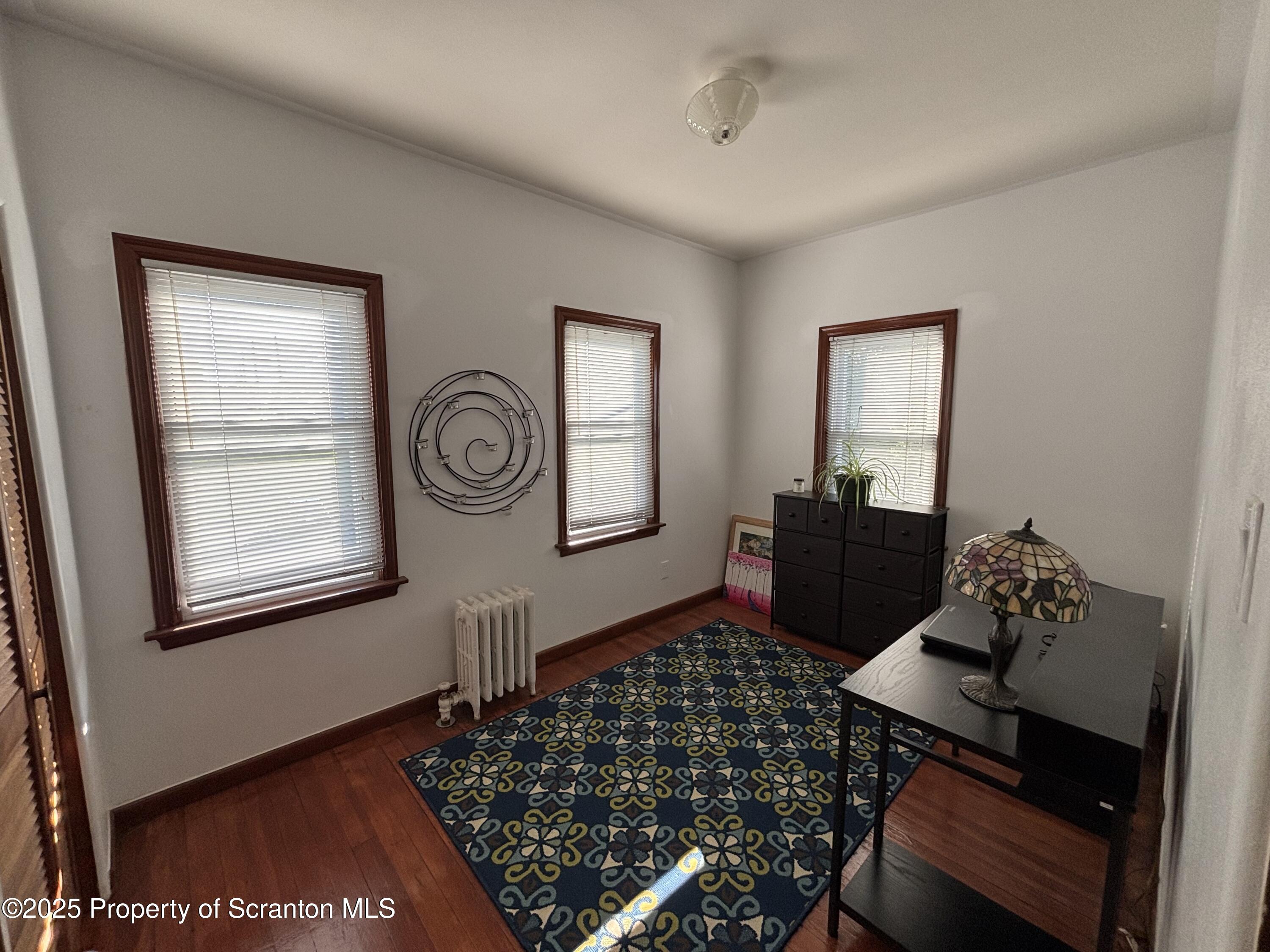 719 Saginaw Street Scranton, PA 18505 - Photo 19 of 23 a room with furniture and wooden floor