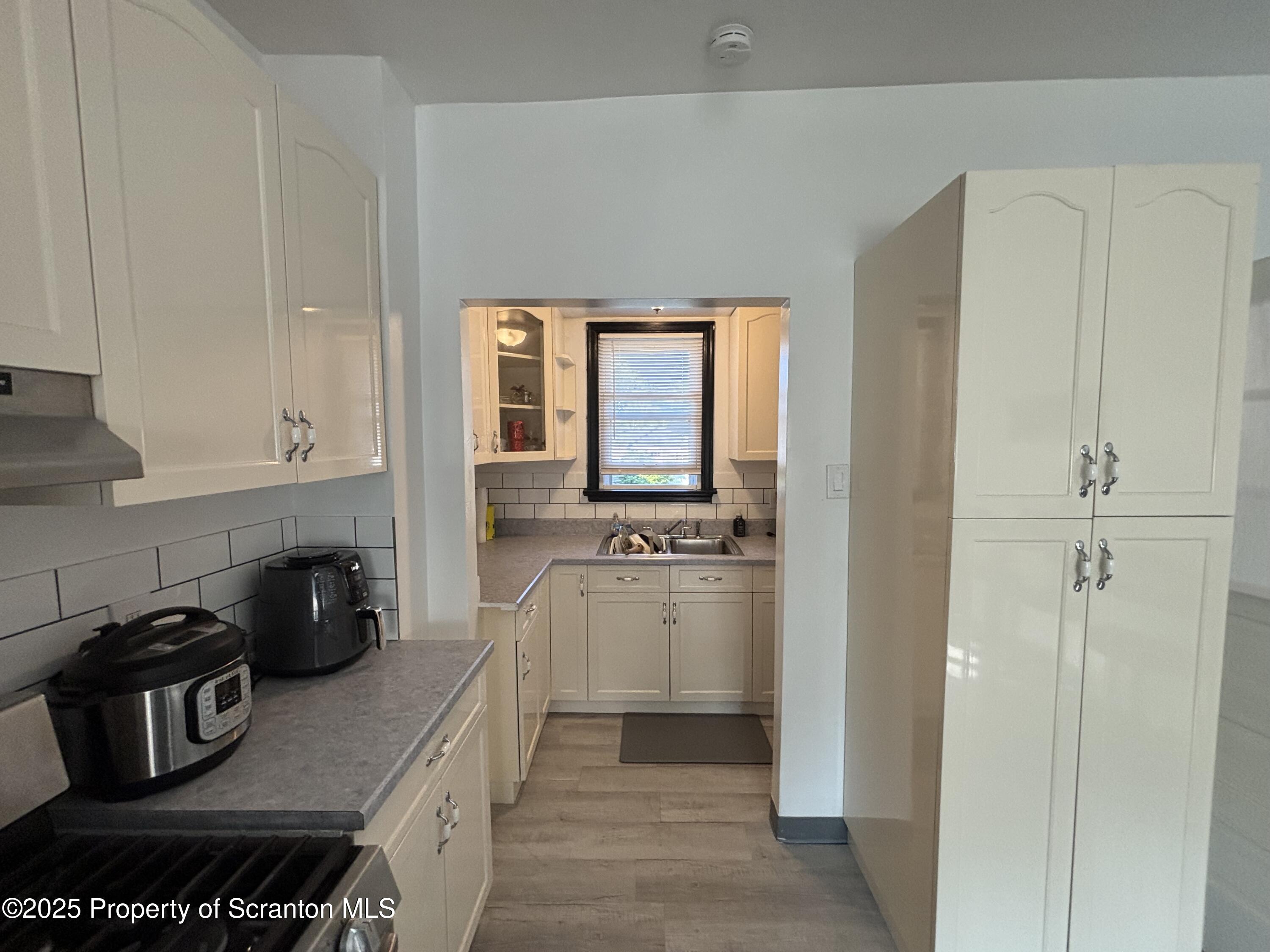 719 Saginaw Street Scranton, PA 18505 - Photo 9 of 23 a kitchen with stainless steel appliances granite countertop a stove and a refrigerator