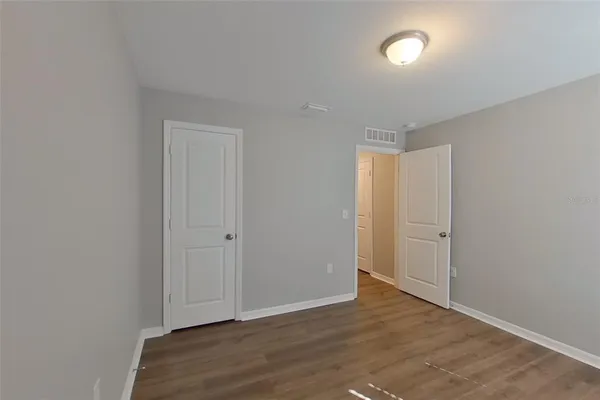 a view of an empty room and wooden floor