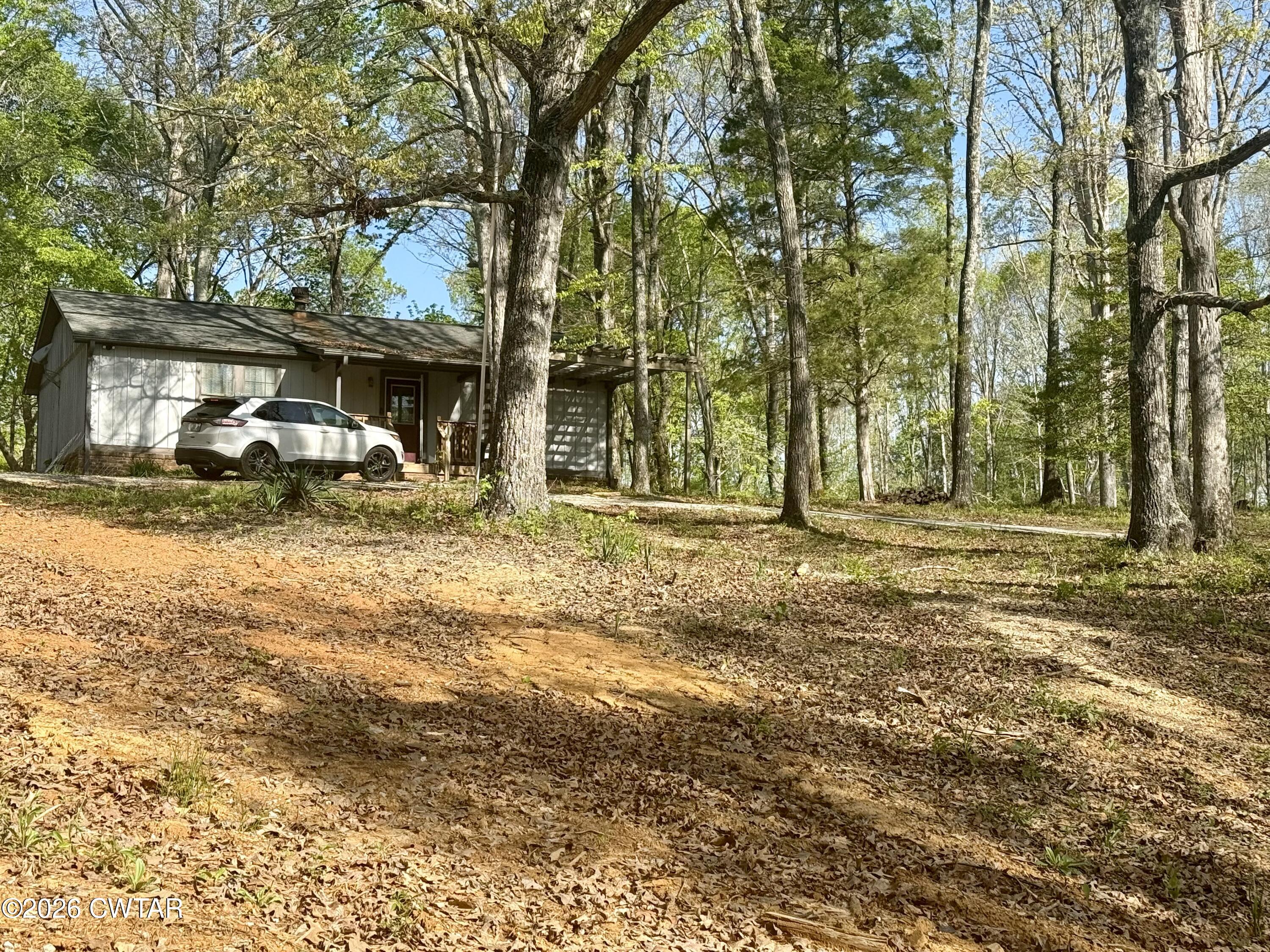 2810 Blue Goose Road Huron, TN 38345 - Photo 1 of 2 a view of outdoor space with deck and tree