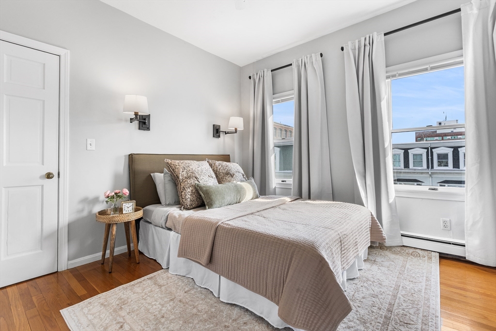 100 Pearl Street, Unit 2 Boston, MA 02129 - Photo 13 of 25 a bedroom with a bed and a refrigerator