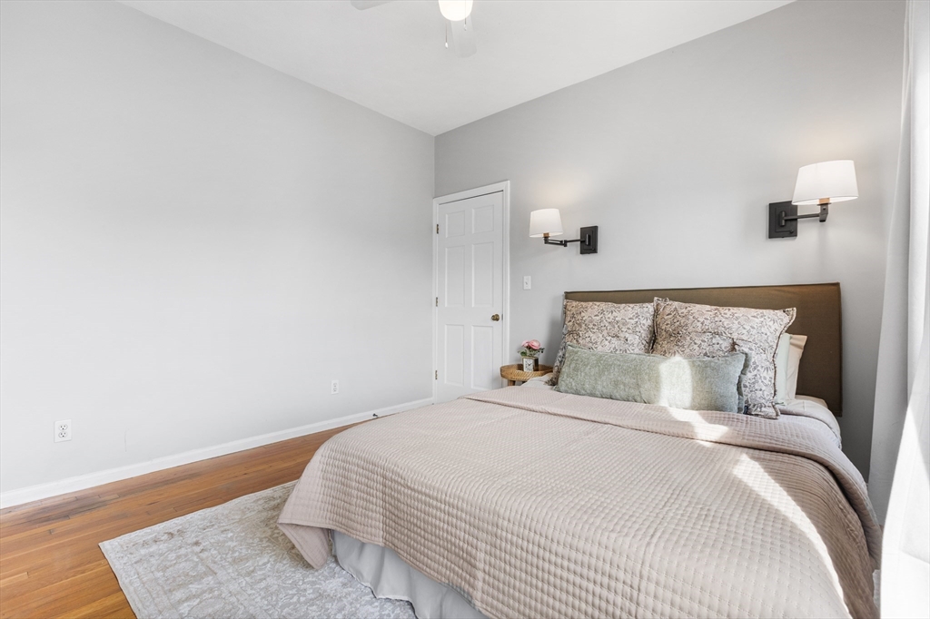 100 Pearl Street, Unit 2 Boston, MA 02129 - Photo 15 of 25 a bedroom with a bed and a wooden floor