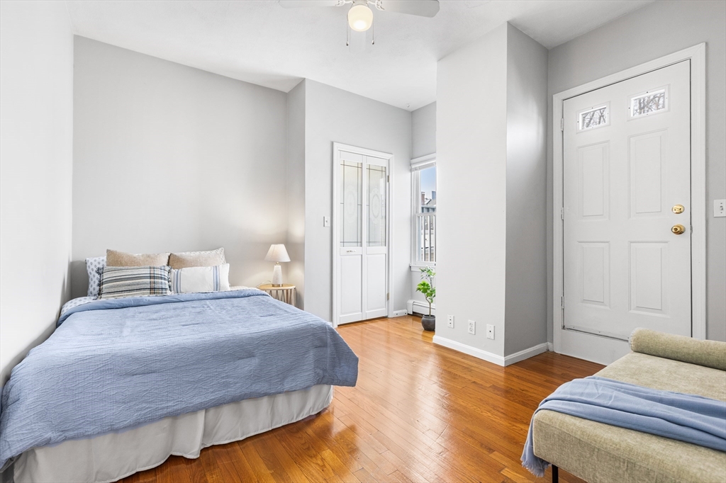 100 Pearl Street, Unit 2 Boston, MA 02129 - Photo 16 of 25 a bedroom with a bed and wooden floor