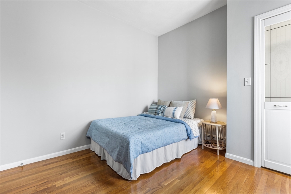 100 Pearl Street, Unit 2 Boston, MA 02129 - Photo 17 of 25 a bedroom with a bed and wooden floor