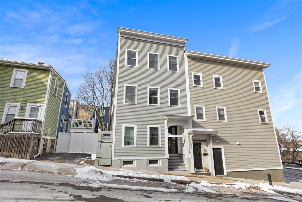 100 Pearl Street, Unit 2 Boston, MA 02129 - Photo 21 of 25 a front view of a house with a yard