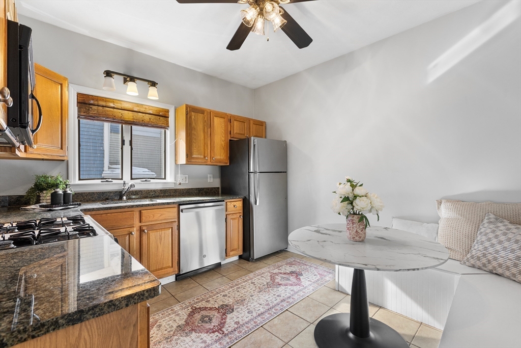 100 Pearl Street, Unit 2 Boston, MA 02129 - Photo 6 of 25 a kitchen with stainless steel appliances granite countertop a sink a stove and refrigerator