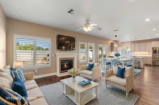 a living room with furniture fireplace and flat screen tv