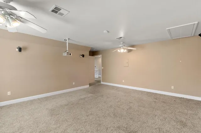 a view of a livingroom with stairs and a floor to ceiling window