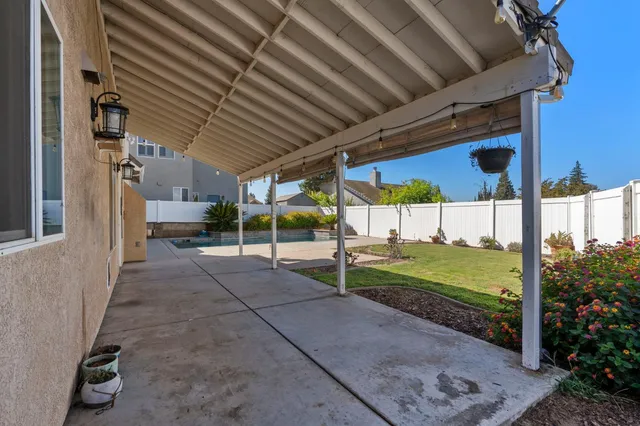 an aerial view of residential house with yard and mountain view in back