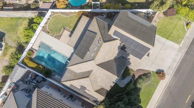an aerial view of a house with a garden and plants