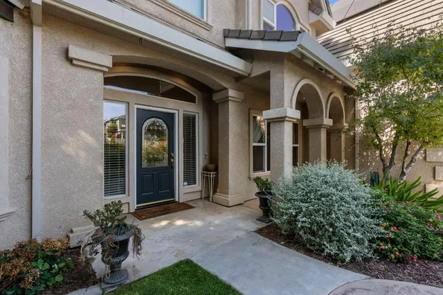 a front view of a house with a garden