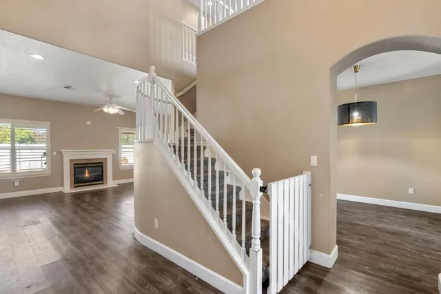 a view of a livingroom with wooden floor and staircase